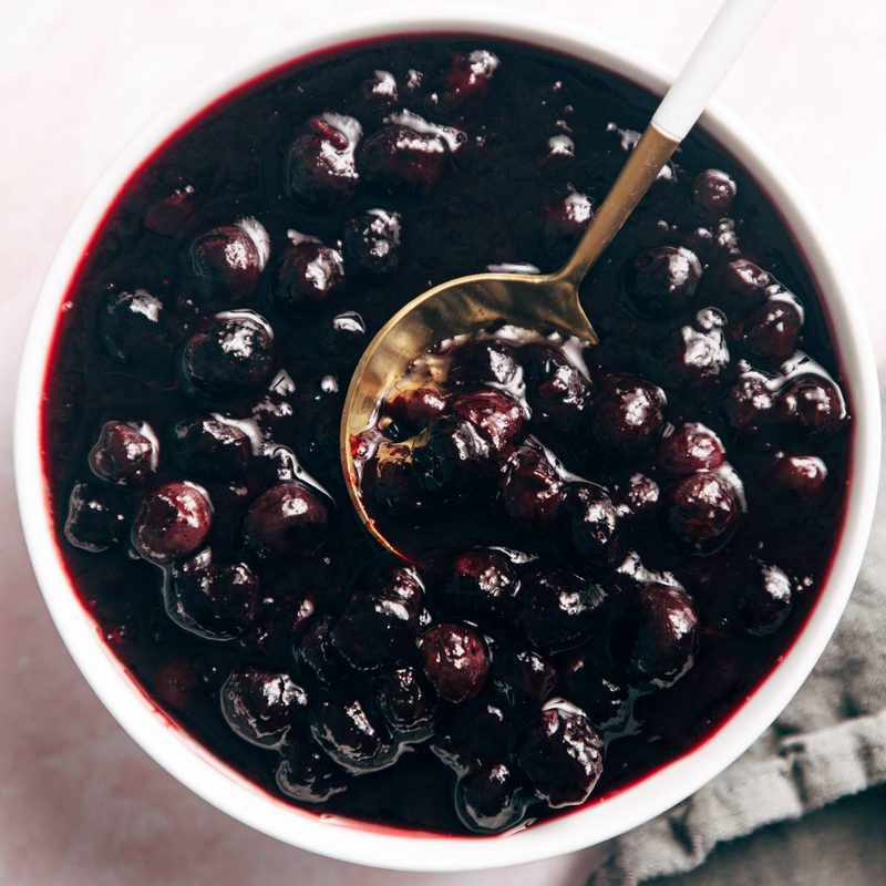Blueberry sauce in a bowl with a spoon