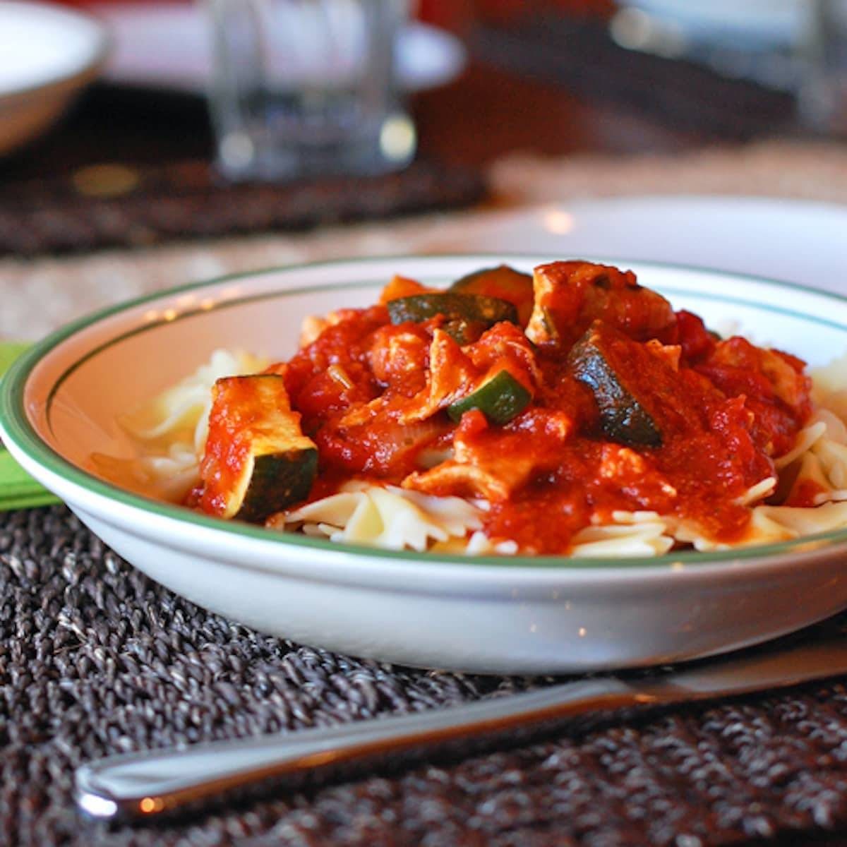 Chicken zucchini pasta in a bowl with a fork.