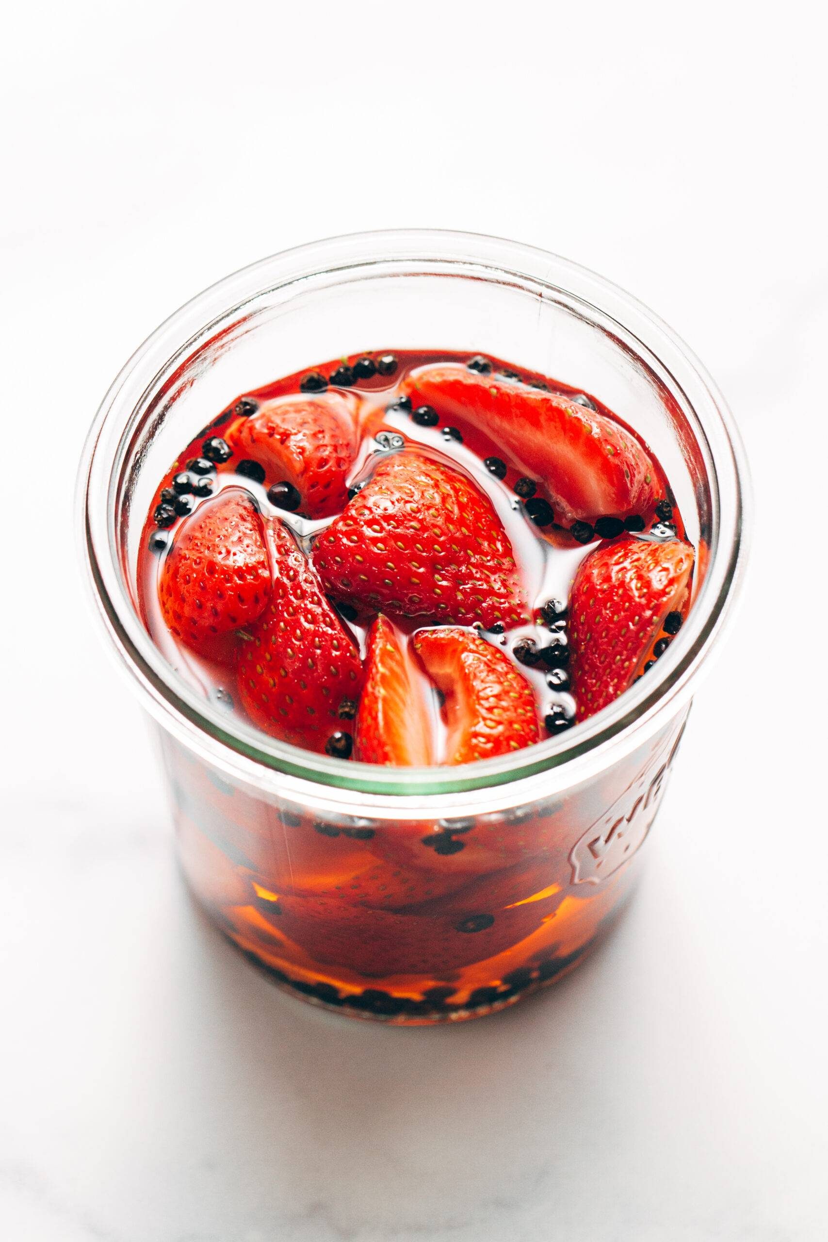 Jar of marinating pickled strawberries